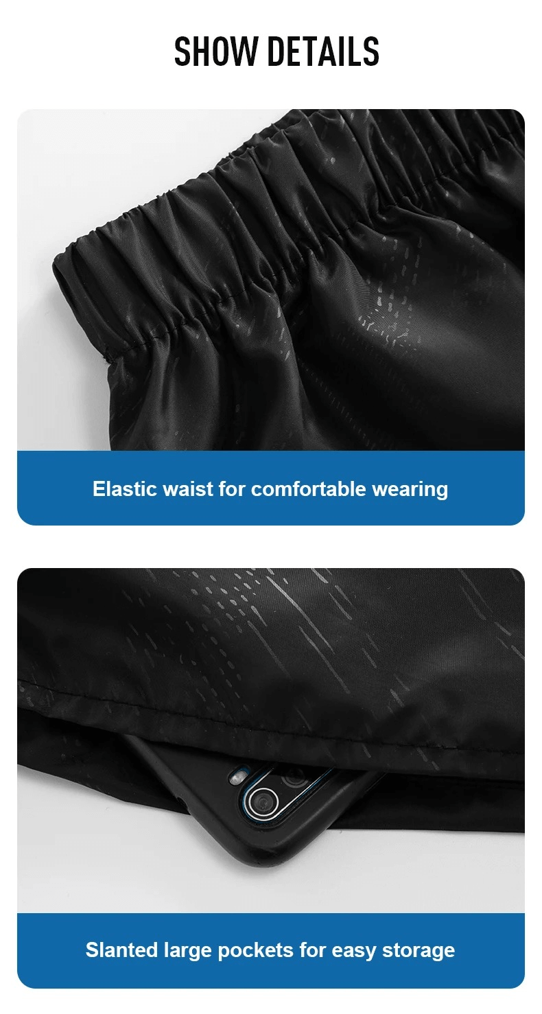 Close-up of black polyester track pants showing elastic waist for comfort and slanted pockets for convenient storage, ideal for outdoors.